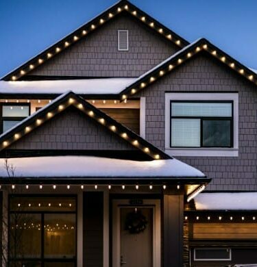 Christmas lights outlining a home and brightening the front yard