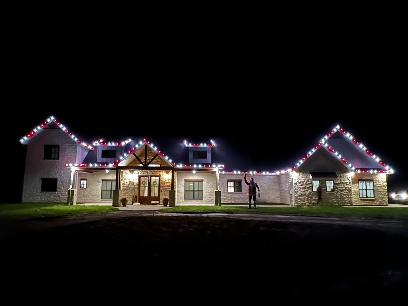 Multicolor Christmas lighting across a residential roofline